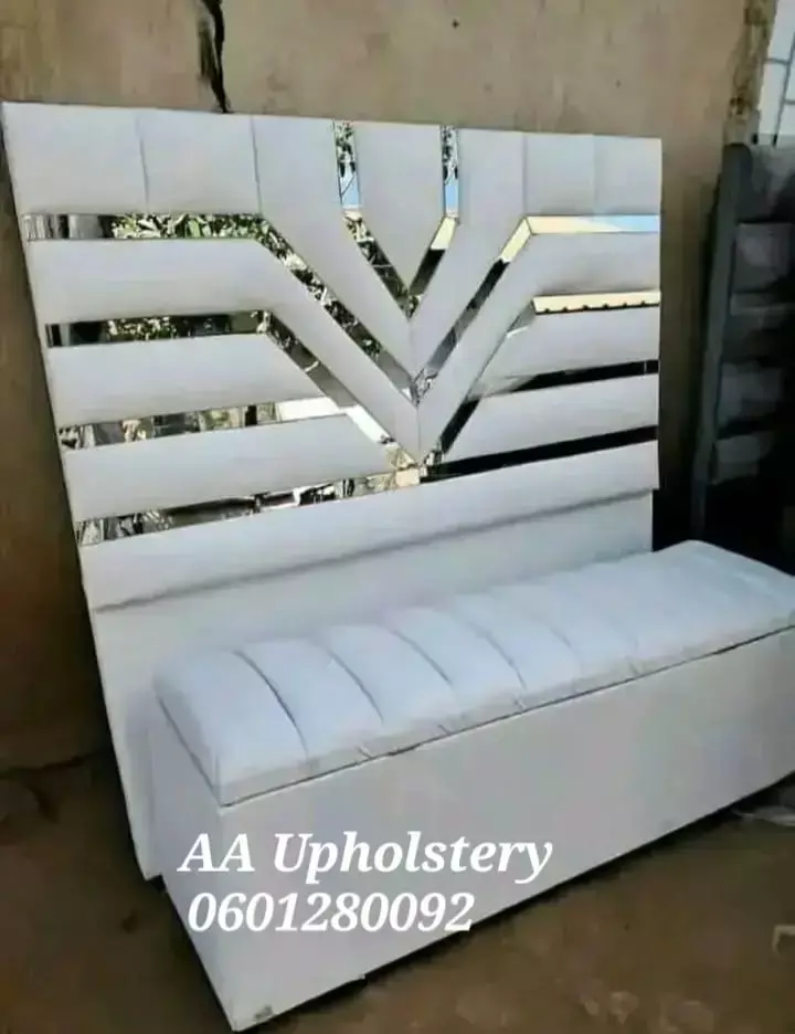 White upholstered headboard and matching tufted bench with mirrored geometric inserts