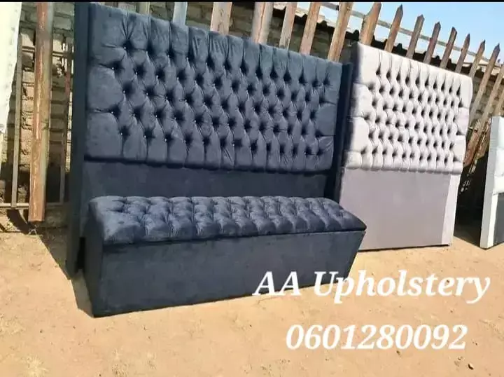 Tufted black upholstered headboard with matching storage bench outdoors