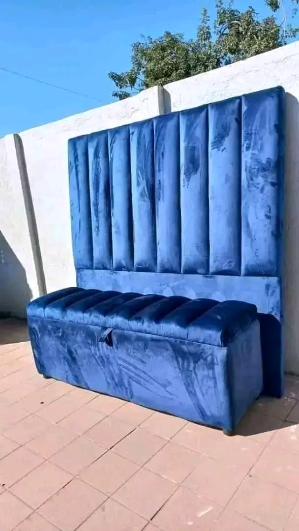 Blue velvet channel-tufted headboard with matching storage bench